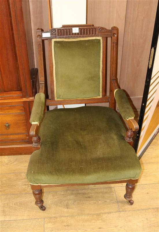 A pair of Edwardian ladies and gentlemens elbow chairs